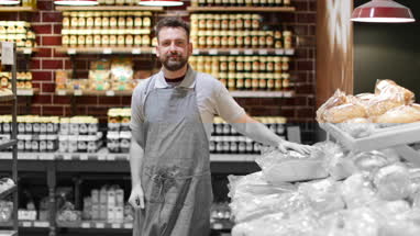Baker in bakery looking to camera