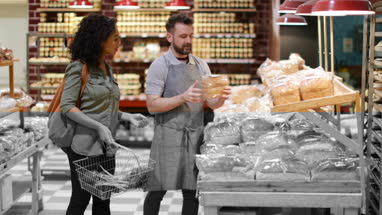 Baker helping customer in grocery store