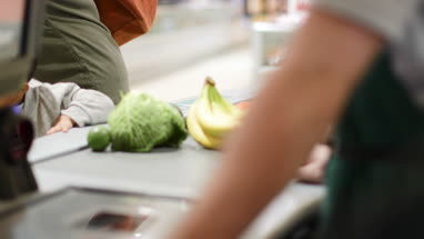 Mother and son at grocery checkout scan