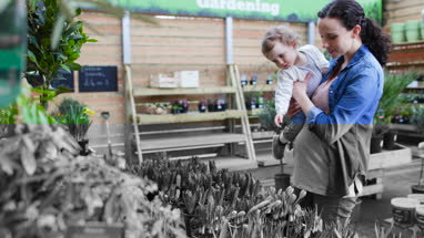 Pregnant mother with daughter at garden centre