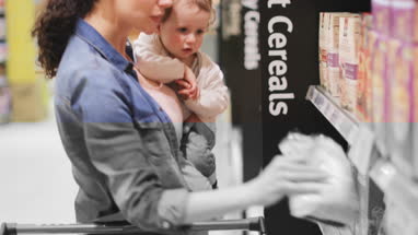 Pregnant mother with daughter grocery shopping
