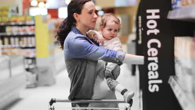 Pregnant mother with daughter grocery shopping