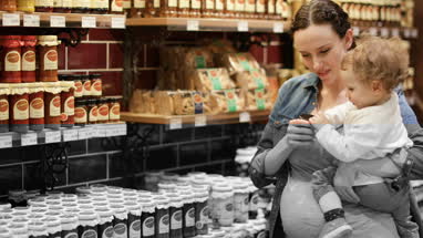 Pregnant mother with daughter grocery shopping