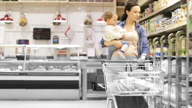 Pregnant mother with daughter grocery shopping