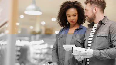 Couple choosing a ready meal in grocery store