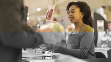 Customer paying for groceries at till