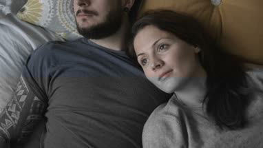 Overhead shot young couple relaxing in bed