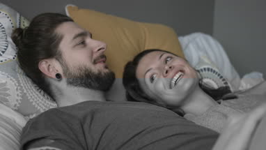 Young couple relaxing in bed