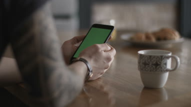 POV young adult male using smartphone