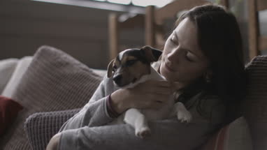 Young female with puppy at home