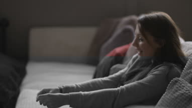 Young female playing with puppy at home