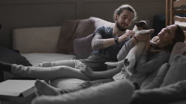 Young couple with pet puppy Jack Russell