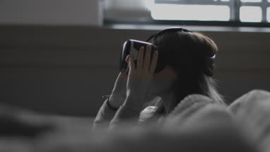 Young adult female using VR headset