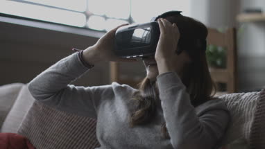 Young adult female using VR headset