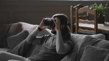 Young adult male using VR headset