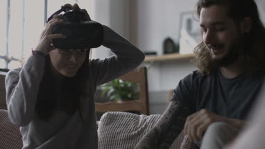 Boyfriend videoing girlfriend using VR headset