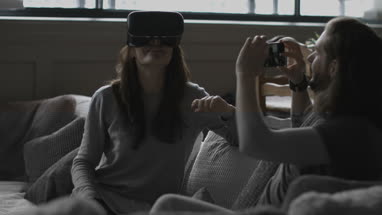 Boyfriend videoing girlfriend using VR headset