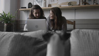 Young adult couple using a laptop together