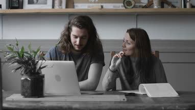 Young adult couple using a working on finance application together