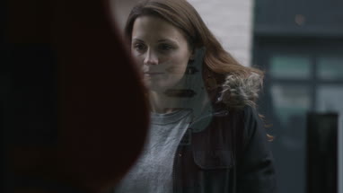 Young adult female looking at guitar through window