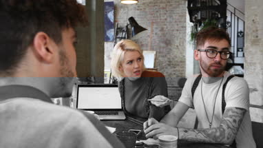 Group of young entrepreneurs listening to a presentation