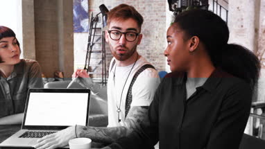 Group of young entrepreneurs listening to a presentation