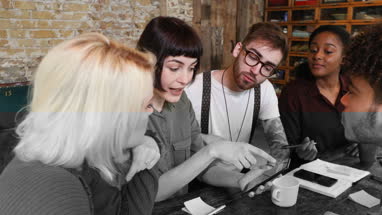 Group of young entrepreneurs working on an app
