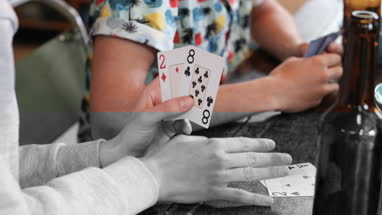 Close-up of hands holding playing cards