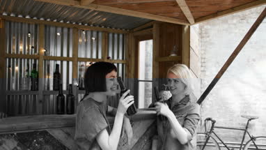 Two friends at a street food bar drinking beer