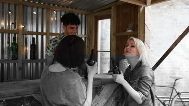 Two friends at a street food bar being served beer