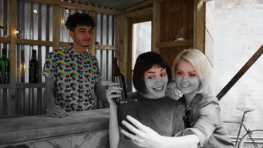 Two friends at a street food bar taking selfie