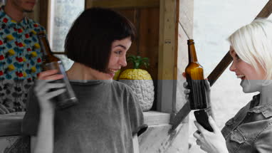Two friends at a street food bar being served beer