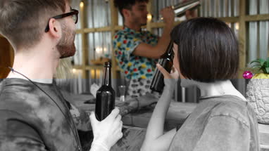 Two friends at a street food bar being served beer