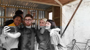 Group of friends at a street food bar taking selfie