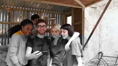 Group of friends at a street food bar looking at smartphone