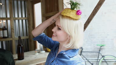 Young adult female posing with a pineapple on her head