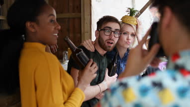 Friends taking picture with retro camera at bar