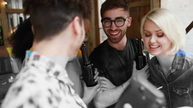 Friends taking picture with retro camera at bar