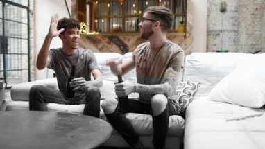 Two male friends watching sport