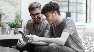 Two male friends looking at a smartphone