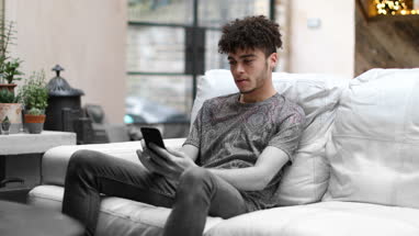 Young adult male on smartphone