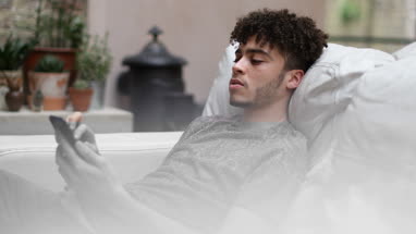 Young adult male on smartphone