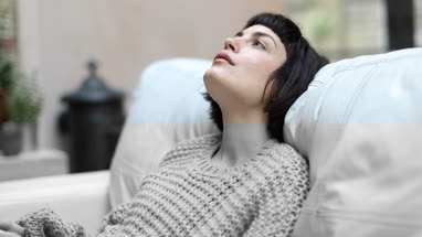 Young adult female looking thoughtful at home