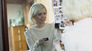 Young adult female looking at photos of friends