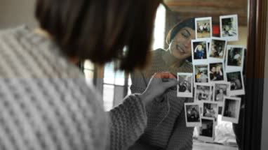 Young adult female looking at photos of friends