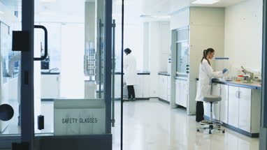 Female scientist discussing experiment with a male colleague