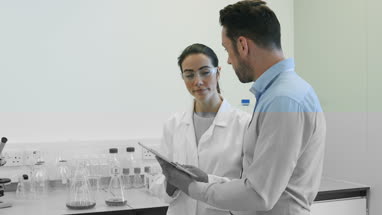 Female scientist discussing data with pharmaceutical sales rep