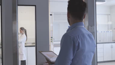 Pharmaceutical sales representative entering science laboratory