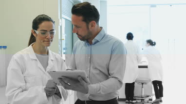 Female scientist discussing data with pharmaceutical sales rep