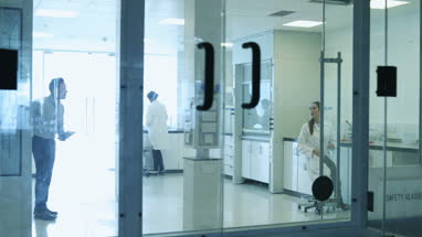 Female scientist shaking hands with pharmaceutical sales rep